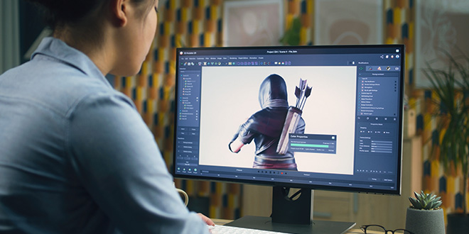 A young man playing video game on a PC